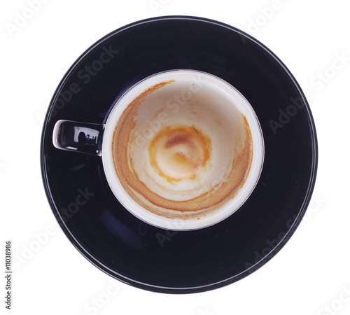 Black ceramic cup of espresso. Used and empty. Isolated.