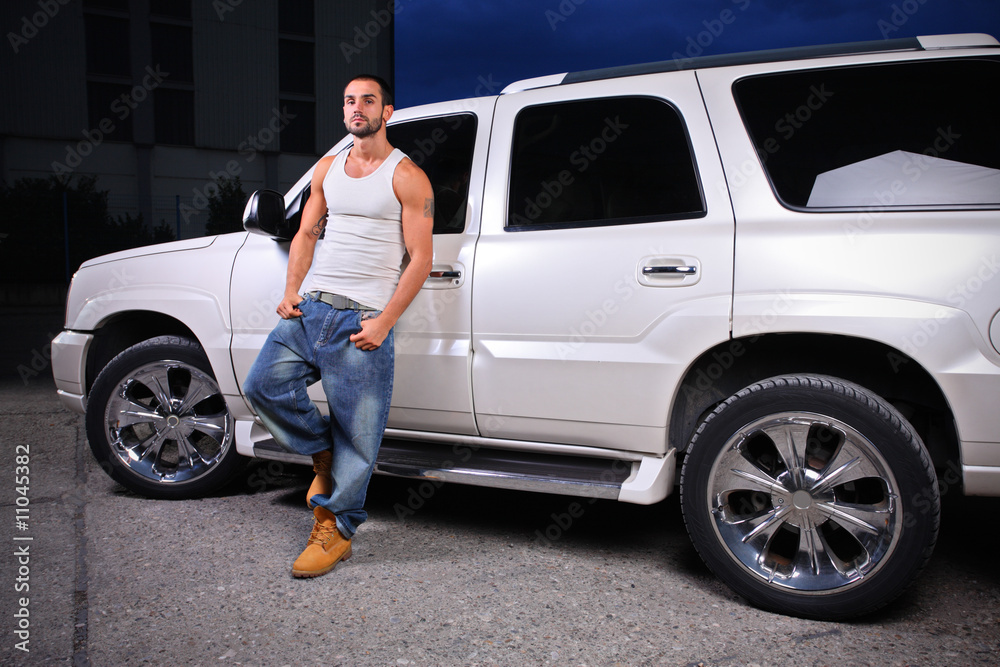 Young person standing next to an SUV