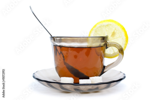 Teacup, lemon slice and some sugar pieces