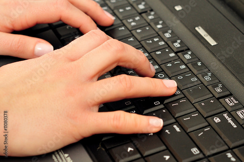 Female hands on laptop keyboard