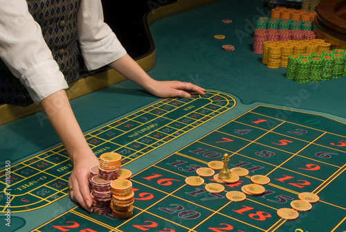 Casino dealer handling a big pile of chips