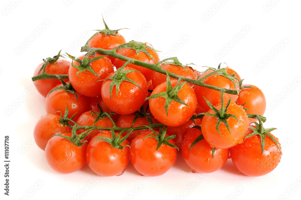 Bunch of cherry tomatoes with water drops isolated on white Bunch of cherry tomatoes with water drops isolated on white