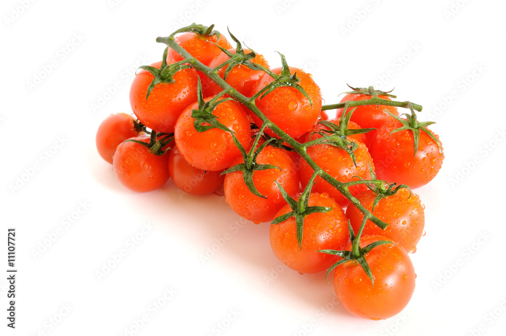 Bunch of cherry tomatoes with water drops isolated on white Bunch of cherry tomatoes with water drops isolated on white