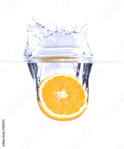 fresh orange splashing into water