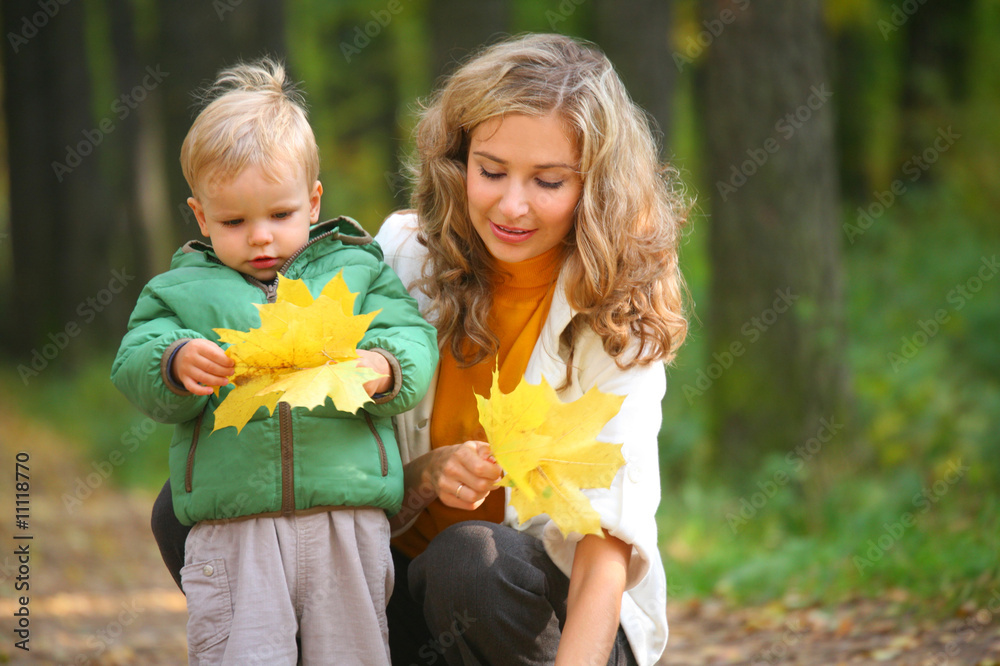mother with child in autumnal wood