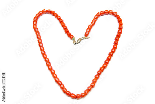 Red necklace on a white background, isolated, heart shape