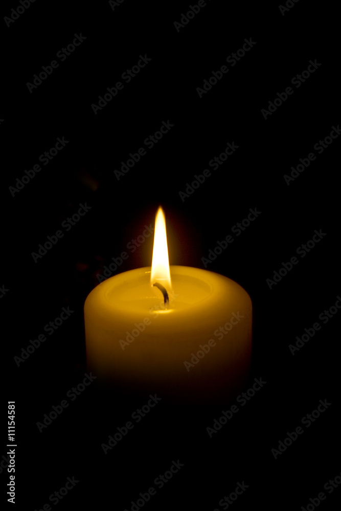 White candle on dark background