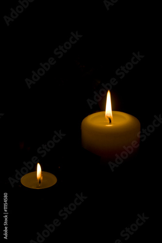 White candles on dark background