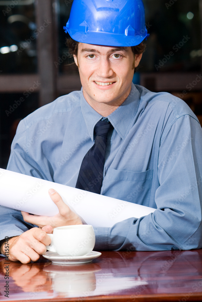 construction manager with blueprint in a cafe construction manager with blueprint in a cafe