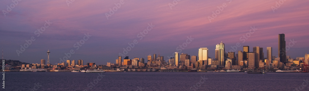 A pink sky over the downtown waterfront in Seattle, Washington.