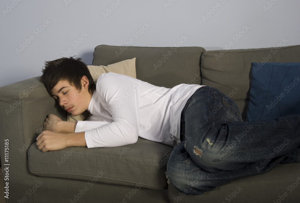 teenage boy sleeping on couch