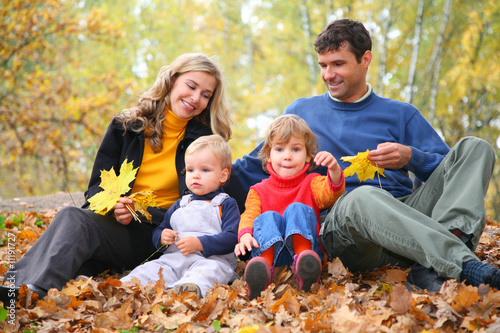 Parents look at children in autumn park