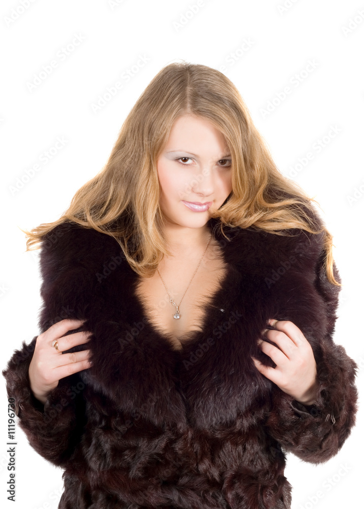 The young beautiful woman in a fur coat over white The young beautiful woman in a fur coat over white