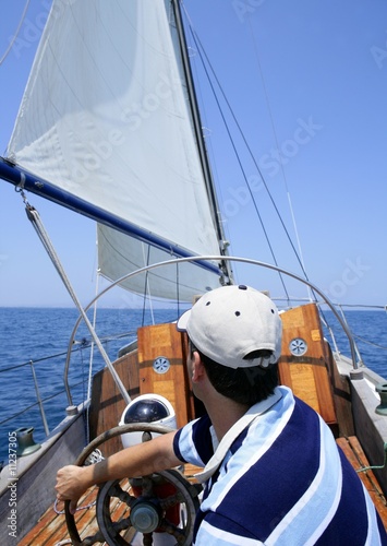 Sailor sailing in the sea. Sailboat over blue