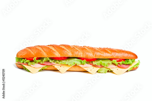 long sandwich with lettuce, tomatoes, ham, turkey and cheese