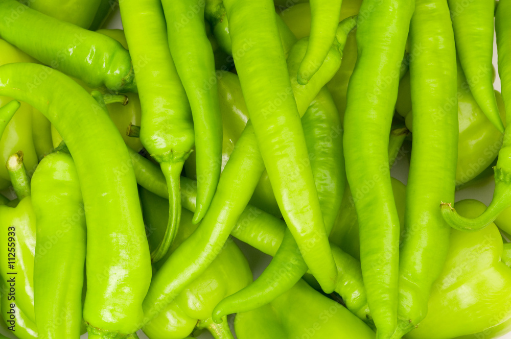 Many green hot peppers arranged at the market Many green hot peppers arranged at the market