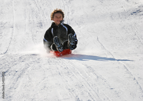 Scared Boy Sledding Fast Down the Hill