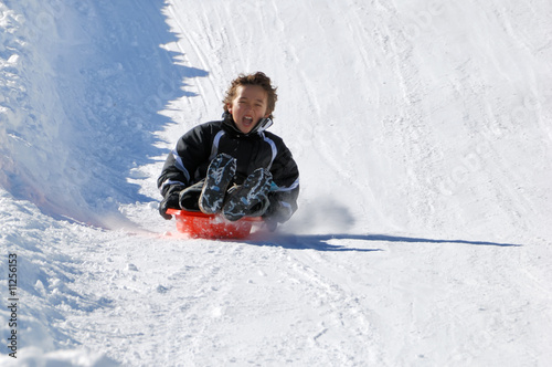 Boy Sledding Down the Hill photo