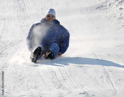 Man Sledding Down the Hill