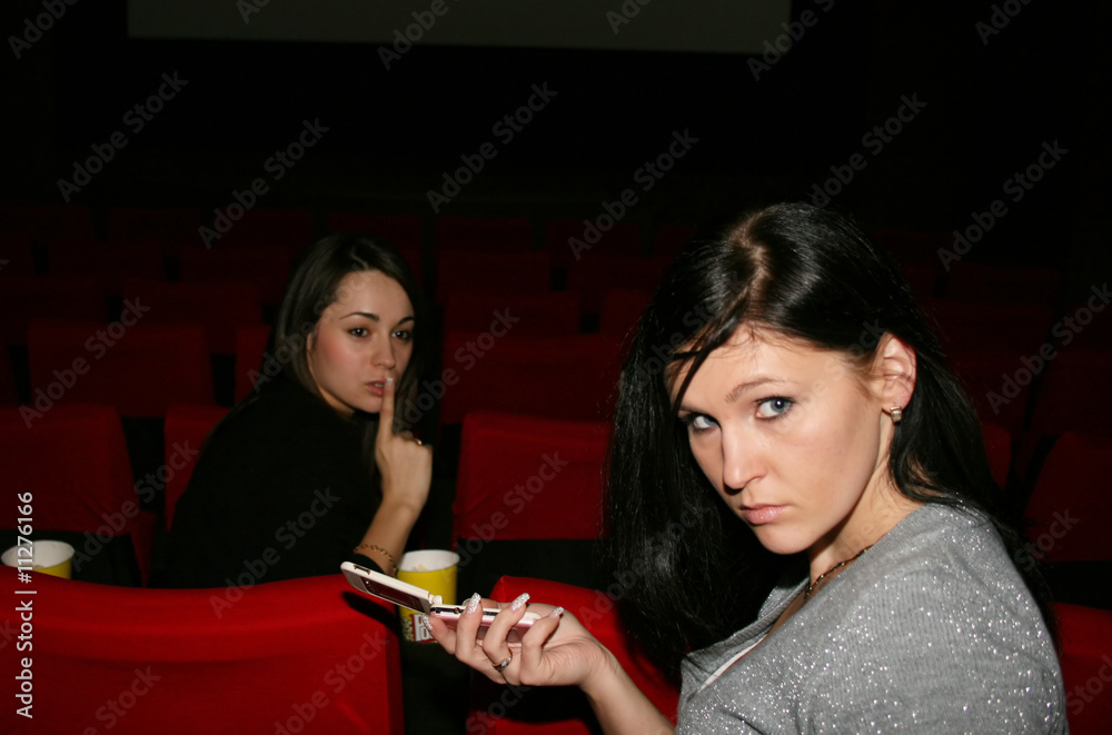 girls are in the cinema, speaks by phone girls are in the cinema, speaks by phone