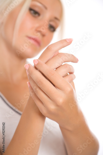 Young woman applying cream to hands