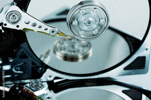 Close-up of hard drives needle and platter with reflection