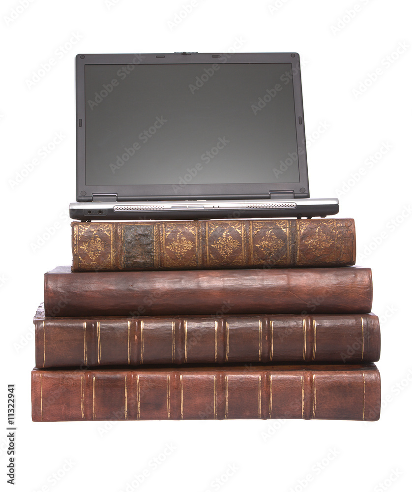 Old leather bound books with a laptop Old leather bound books with a laptop