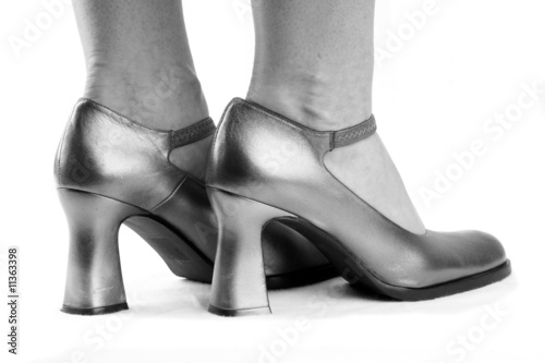 Woman's feet in silvery shoes