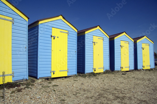 Blue and yellow beach huts © Lance Bellers