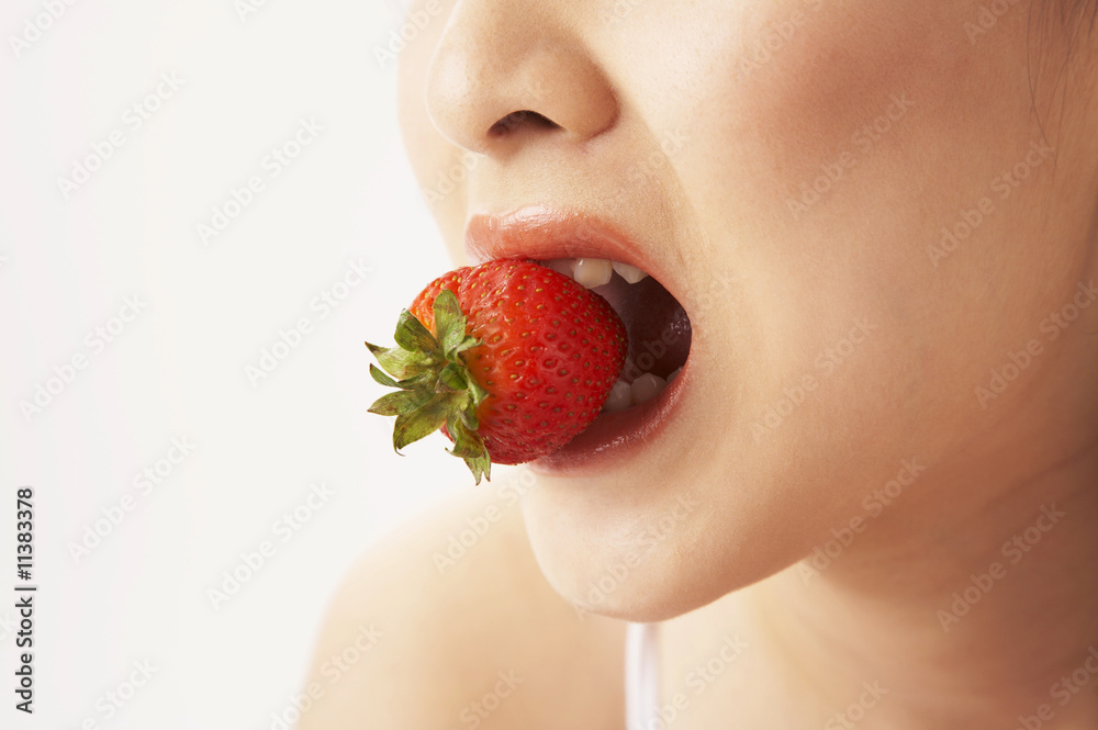 young woman eating strawberry young woman eating strawberry