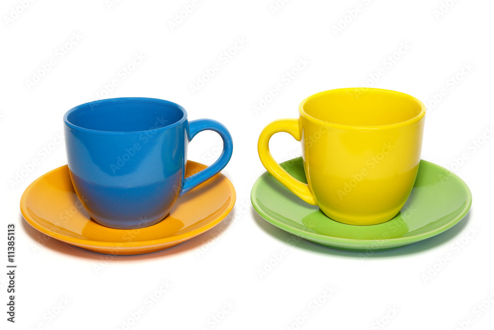 Colored teacups and saucers isolated on white. Colored teacups and saucers isolated on white.