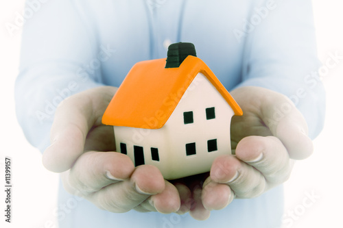 man holding a small house in his hands with dream effect to enph
