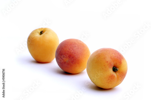 Fresh delicious apricots over white background