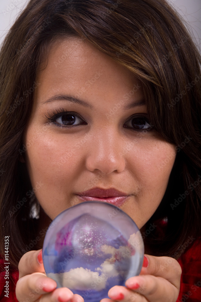 A young exotic woman offers a crystal ball A young exotic woman offers a crystal ball