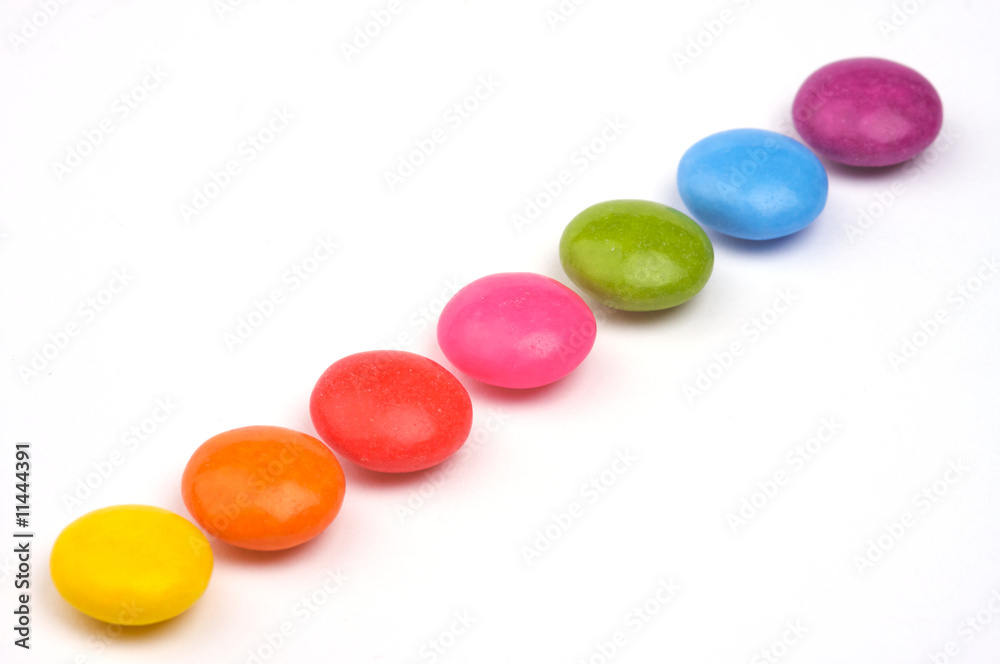 a row of colorful sugar coated candy a row of colorful sugar coated candy