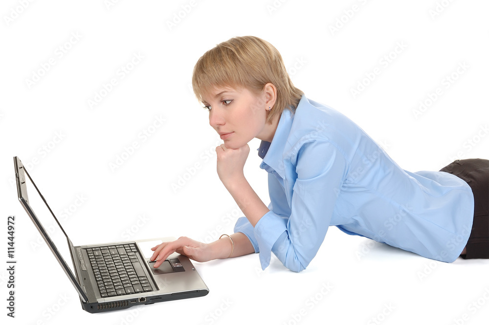 Beautiful businesswoman with laptop lying on the floor. Beautiful businesswoman with laptop lying on the floor.