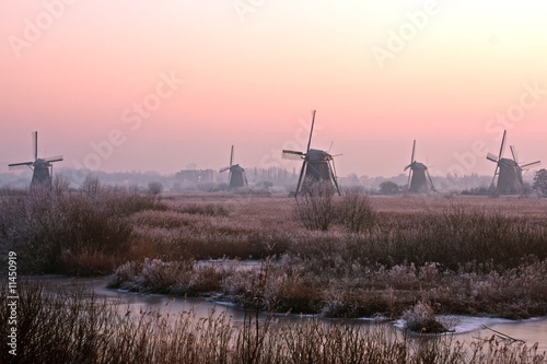 Winmills at the Kinderdijk in the Netherlands at sunset photo