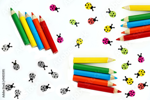 Multicolored crayons and ladybirds composition photo