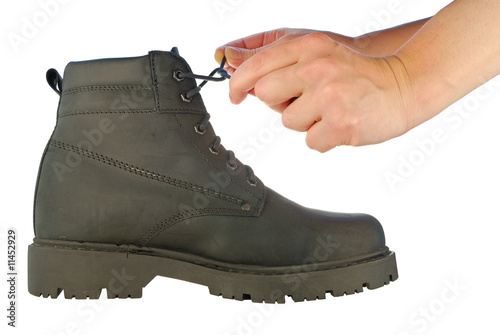 tie shoe-laces on rough boot