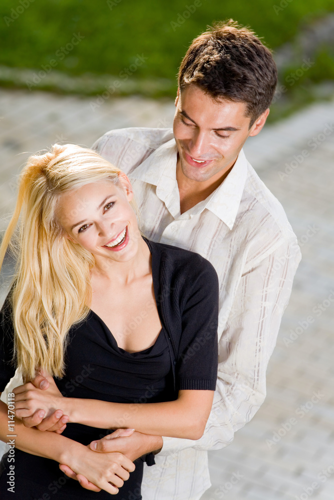 Young happy attractive embracing couple, outdoors Young happy attractive embracing couple, outdoors
