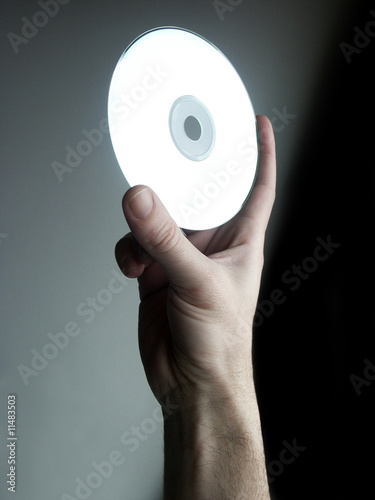 close up shot of a hand holding cd photo