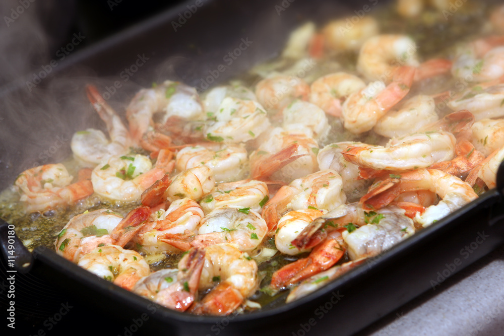 The photograph of fried seafood on the frying pan (shrimps) The photograph of fried seafood on the frying pan (shrimps)