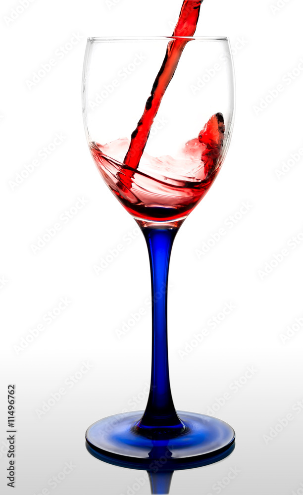 Red wine flowing to a glass. isolated with a clipping path Red wine flowing to a glass. isolated with a clipping path