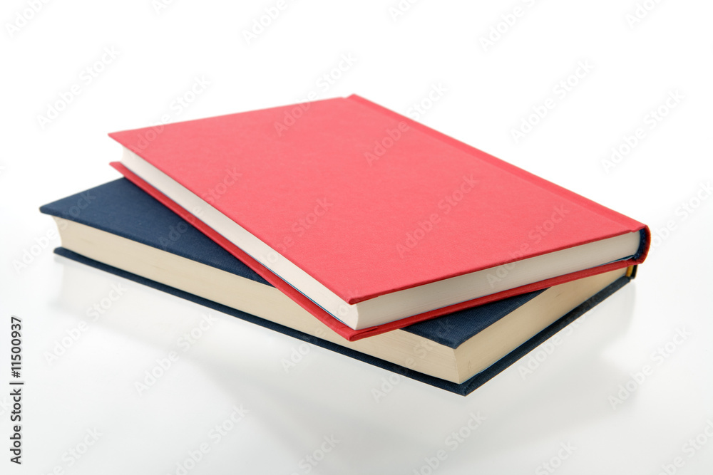 closed red and blue books on reflecting white closed red and blue books on reflecting white