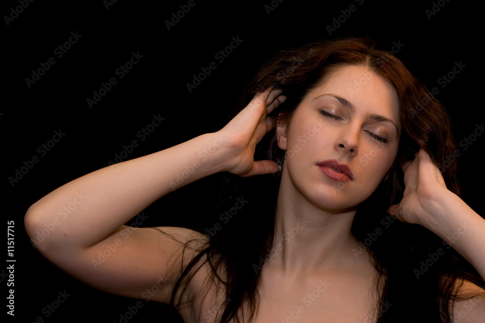 Portrait of a young woman with closed eyes on black background Portrait of a young woman with closed eyes on black background