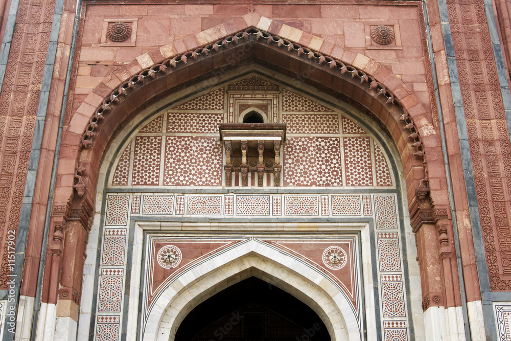 Ornate entrance to an ancient mosque in Delhi, India.