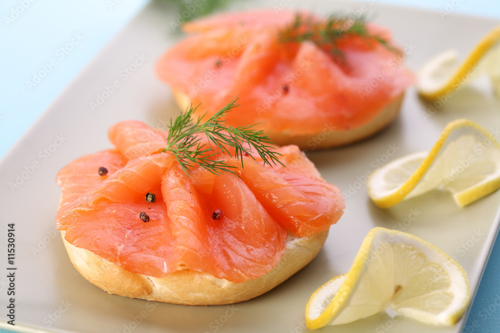 Smoked salmon on bagel with fresh black pepper.