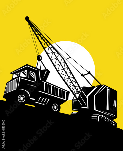 Crane loading a dump truck