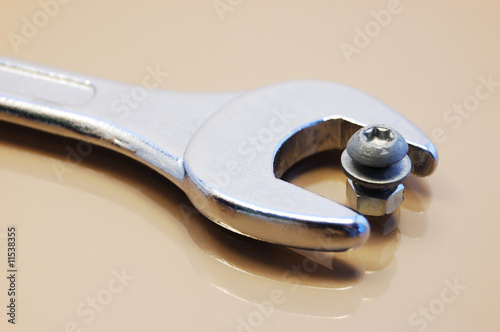Wrong tool: big wrench with little nut and screw