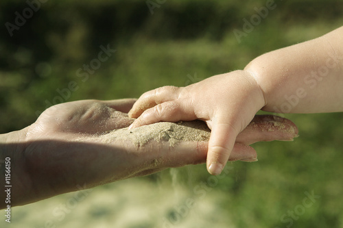 Baby hand with sand